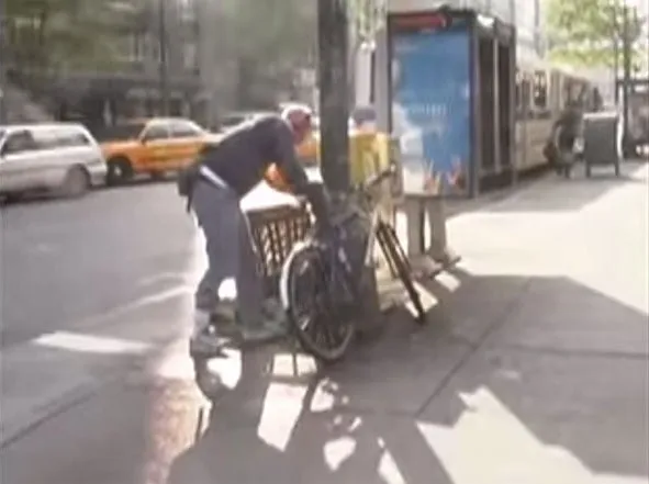 A photo of Van Neistat using an angle grinder to cut the lock of his bike and 'steal' it from a New York street.